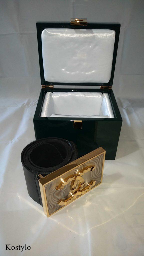 the dark green company-branded box lined with white satin is for storing luxurious belt buckle for luxury skirt dress, handmade by the Kostylo atelier