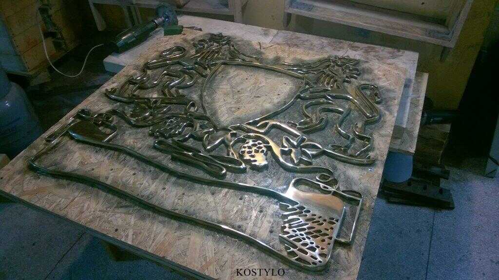 how we create: polishing to high gloss brass openwork bas-relief custom-made for private company by the Kostylo atelier