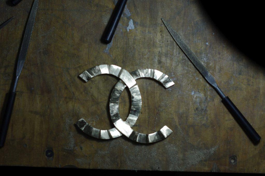 brass Coco Chanel logo inspired by art deco style depicting waves hand-cut in the Kostylo atelier
