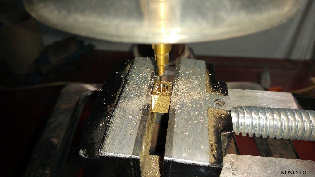 aesthetically drilling hole in brass component to precisely recess screw authored by the Kostylo atelier