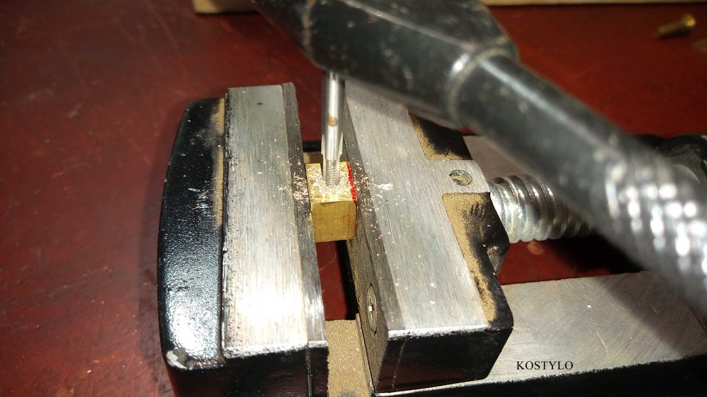 hand-threading brass component for hinges and latches in the Kostylo atelier