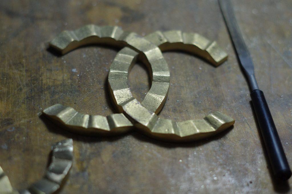 cast from brass in its original state before grinding the coco chanel logo, often has porous surface that will be brought to perfect appearance, authored kostylo atelier