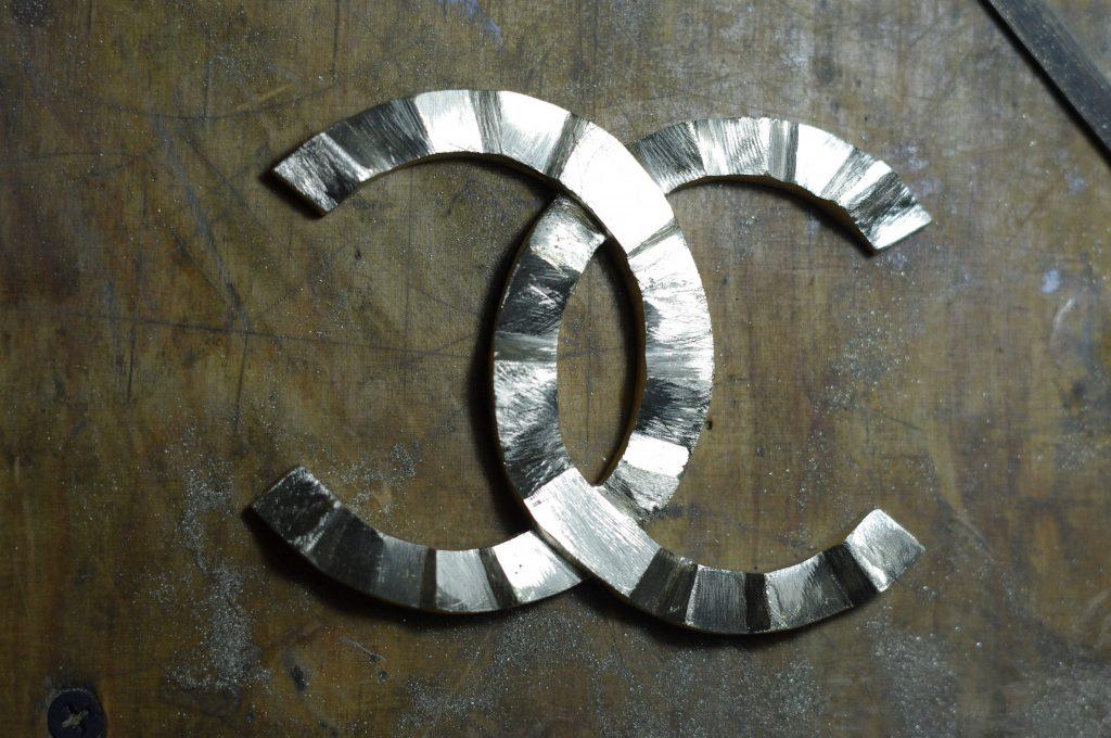 brass cast showing the Coco Chanel logo after the first initial manual grinding handcrafted by kostylo atelier