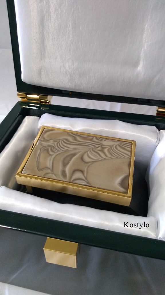 the luxurious dark green company-branded box lined with satin for storing luxury belt buckle encrusted with striped flint handcrafted in the Kostylo atelier