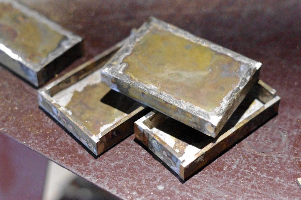 brass trouser buckles after silver soldering are waiting for manual grinding of excess silver, copper plating and gold plating only in the Kostylo atelier