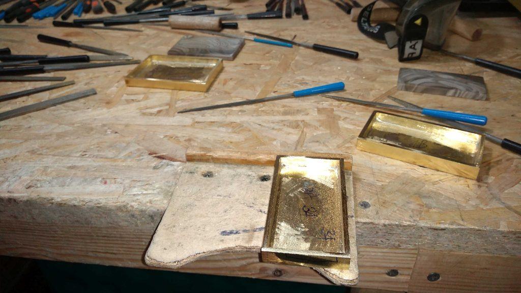 manual grinding of trouser belt buckles on the outside and inside under striped flint in the kostylo atelier