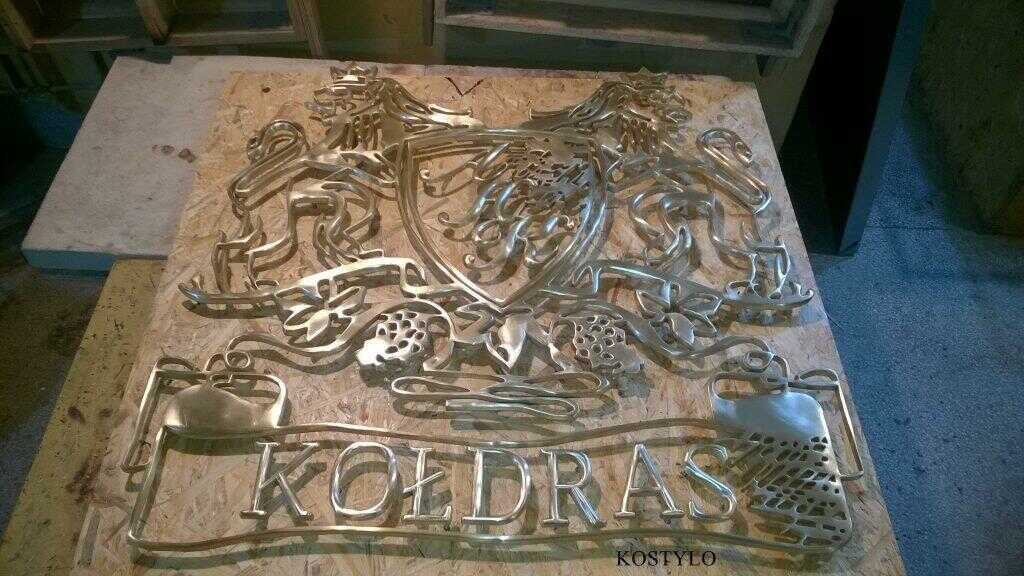 how we create luxurious openwork brass company logo bas-relief, after manual grinding and silver soldering, is ready for hand polishing to high gloss in Kostylo atelier
