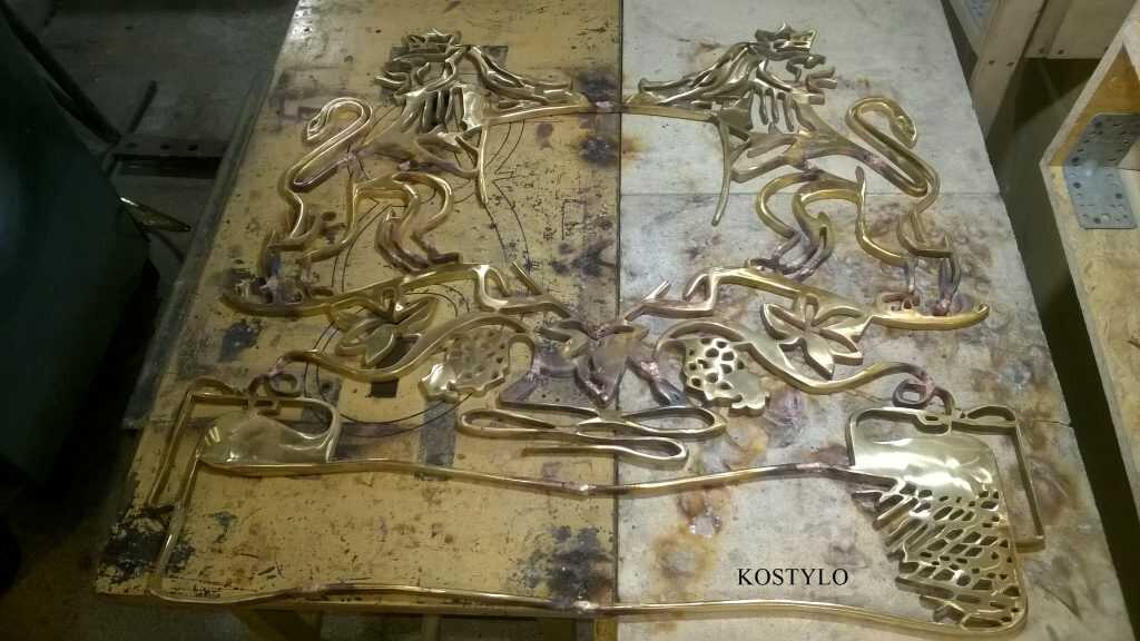 joining the brass elements of an openwork bas-relief for crest logo with two lions using silver soldering in Kostylo atelier