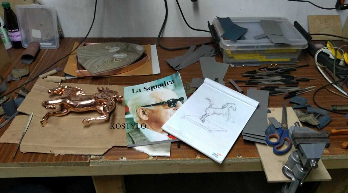 from sketch to copper-plated sculpture figure, prepared sculpture of Ferrari horse with copper-plated base in the shape of the Ferrari coat of arms, ready for silver plating in the Kostylo atelier