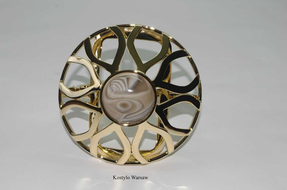 wonderful front shot of beautiful pure gold plated figure of shiny lotus flower ring protecting priceless striped flint handcrafted authored by kostylo atelier