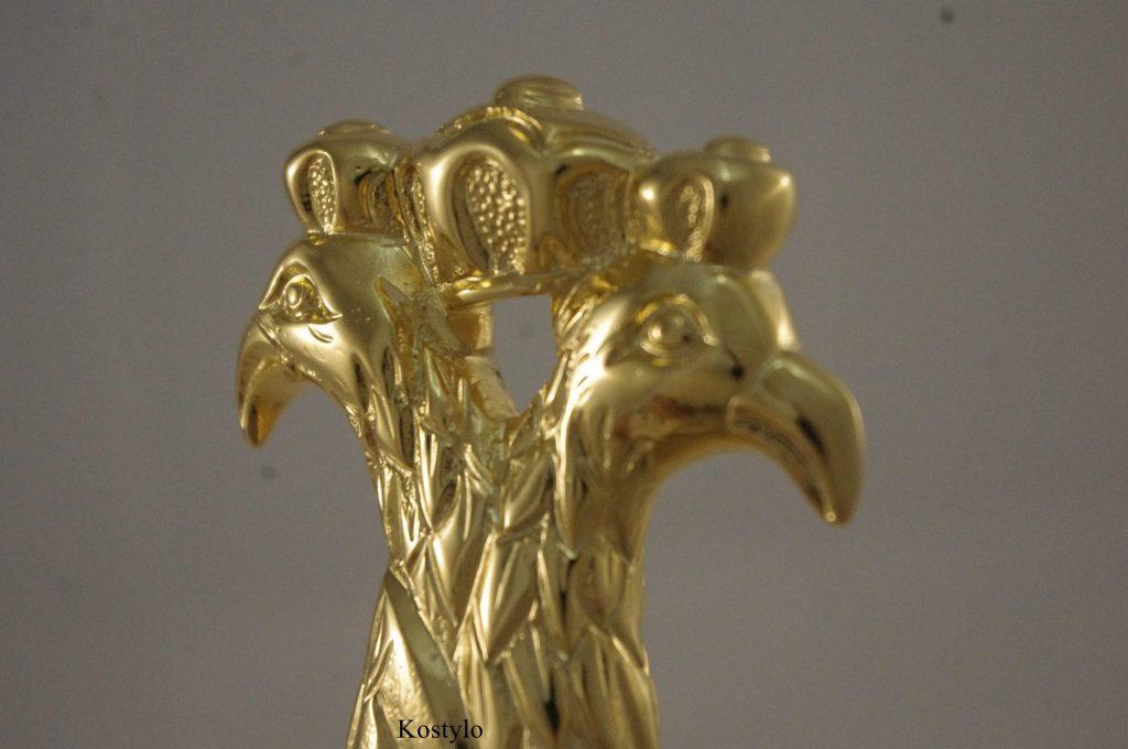 The intricately handcrafted detail of a luxurious gold-plated letter opener with the heads of imperial eagles