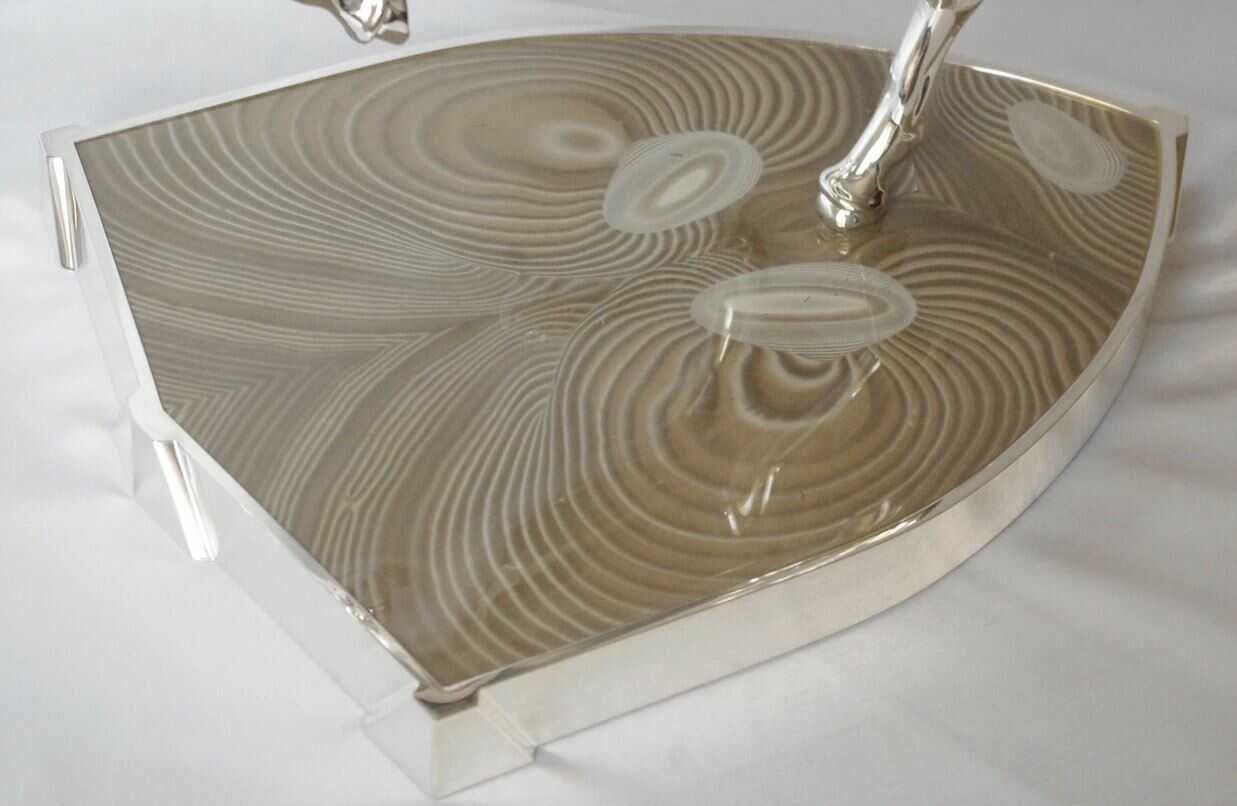 luxury_base_of_ferrari_horse_in_striped_flint_by_kostylo_atelier Luxurious silver plated Ferrari horse figurine with a base shaped like the Ferrari logo intricately crafted from striped flint by the Kostylo Atelier