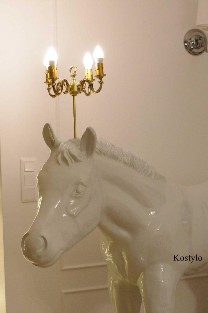 A rare luxurious white horse head handmade with a beautiful brass chandelier lighting on the head authored kostylo atelier