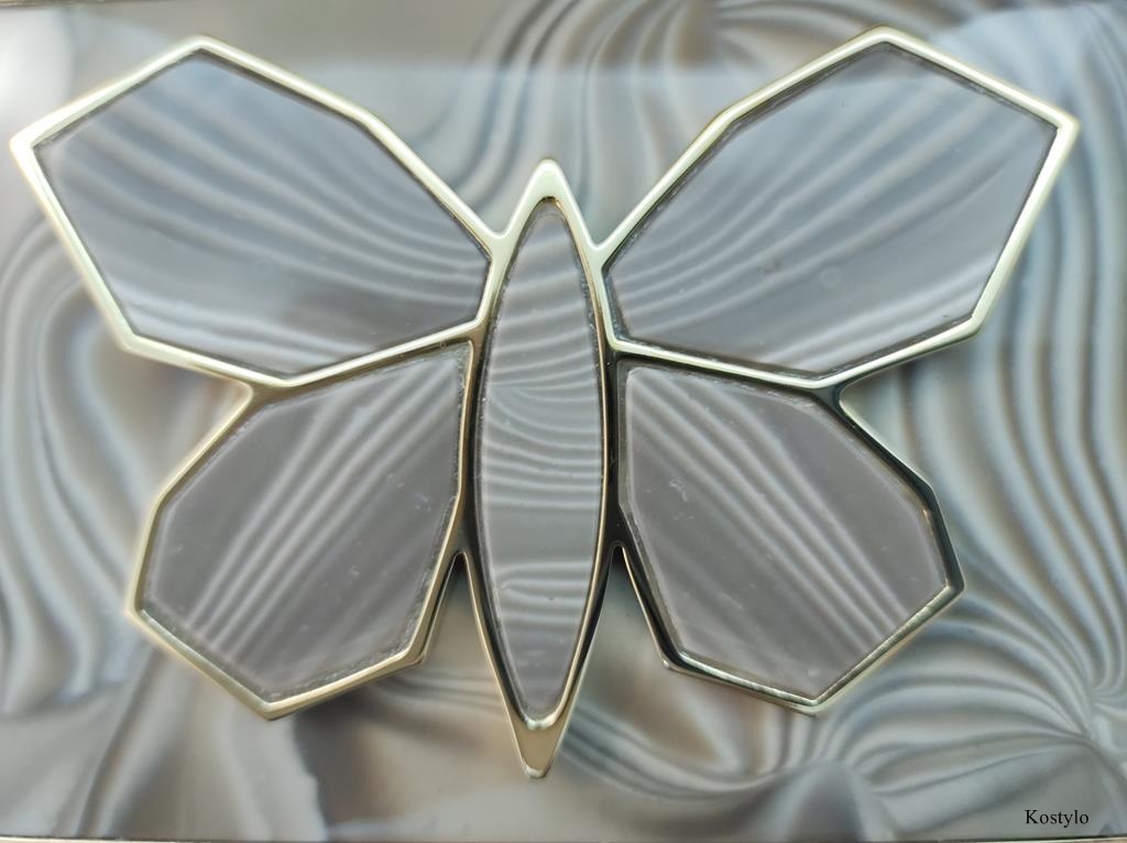 European Design Trouser Buckle with Gold-Plated Butterfly Close-up of a luxurious original 23-carat Italian gold-gilded belt buckle for a dress or trousers with a rare semiprecious striped flint, rarer than diamond