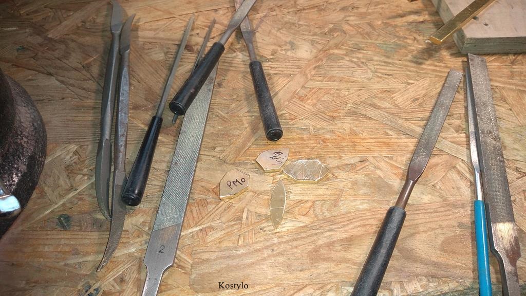 The base elements of the butterfly bas-relief are cut from brass and manually grinded with files by Kostylo atelier