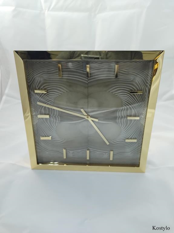 View of an original modern wall clock gilded with light Italian gold with dial made of rare semi-precious striped flint stone by Kostylo atelier