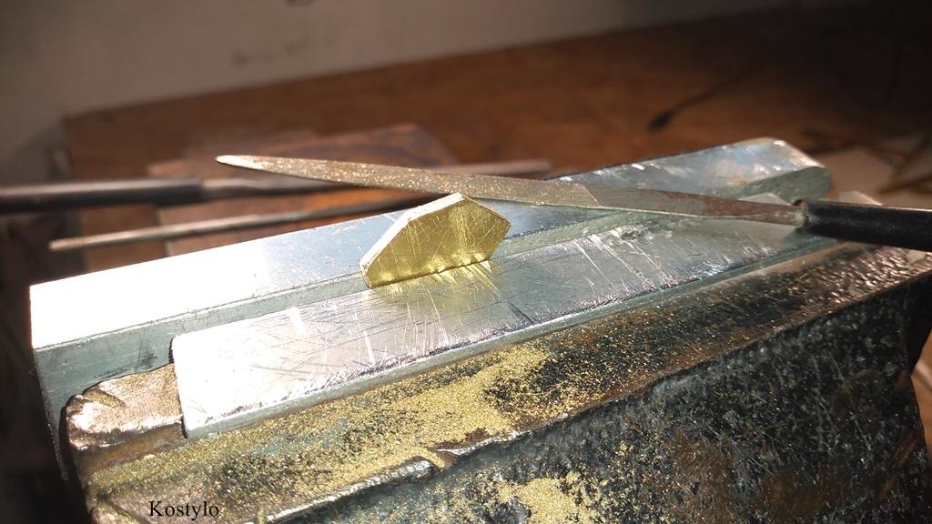 Hand-smoothing the surface of the brass-cut base for the butterfly bas-relief intended for future belt buckle by Kostylo atelier